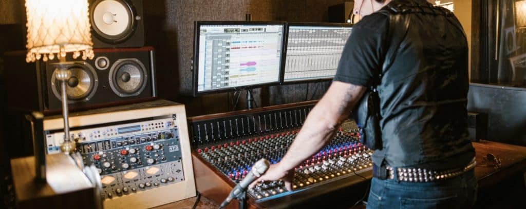 Man in Black Shirt Playing Audio Mixer