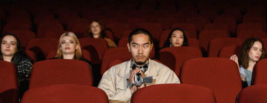 The Dramatic Stages of Tension: How to Create Conflict for your Audience 3 Multiracial People Sitting on Red Theater Seats