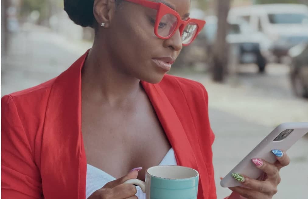 Passive Income Ideas For Artists to Make More in 2022: How to Earn Progressive Passive Income 7 Office Girl using Phone while Holding a Mug
