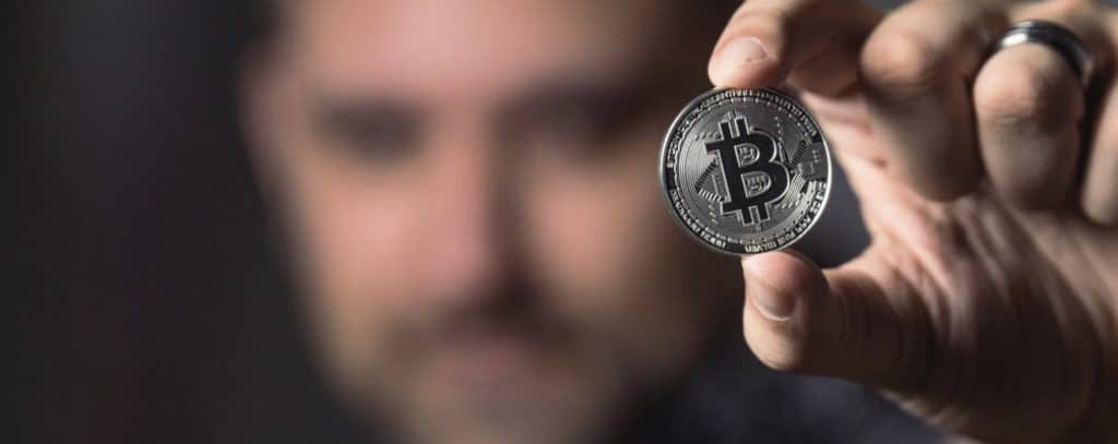 Person Holding Silver Bitcoin Coin