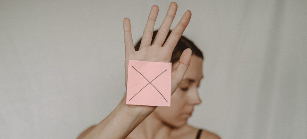 Woman with paper with cross sign