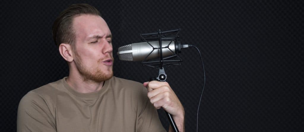 About 3 Musicians producing music in professional recording studio