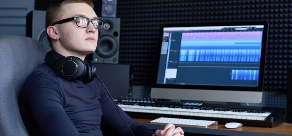 Pensive creative music producer in studio