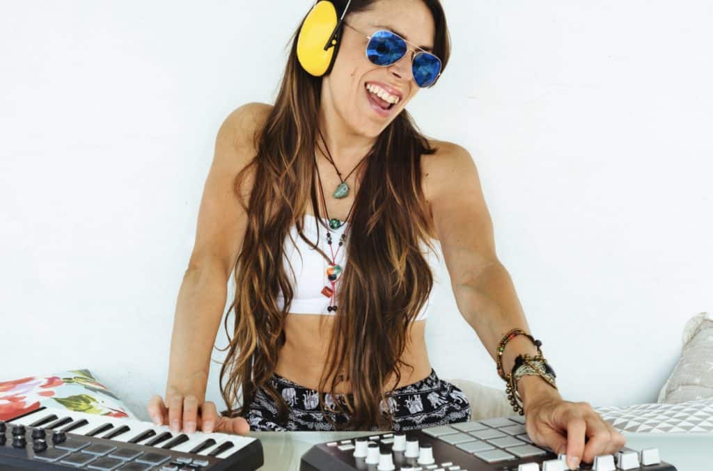 Woman Sitting with Mixing Table and Producing Music 1