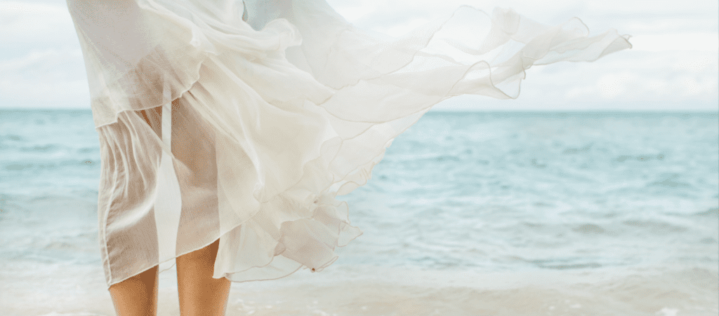 White dress waving on seaside wind