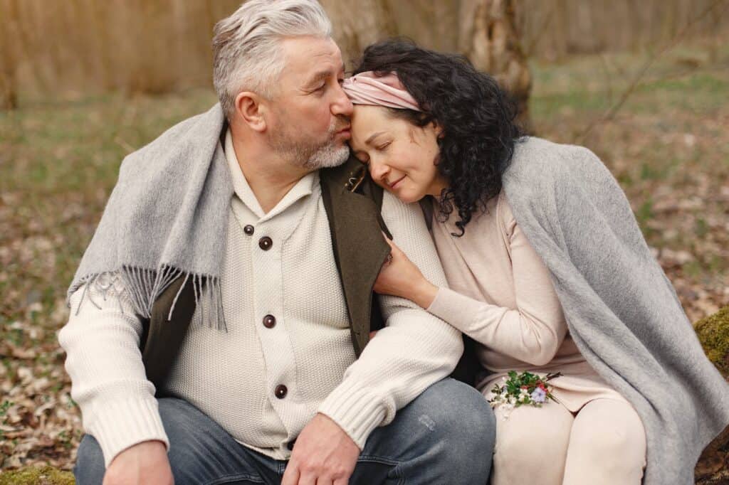 How To Budget For Holiday Spending In An Economic Downturn 3 happy senior couple hugging in autumn park
