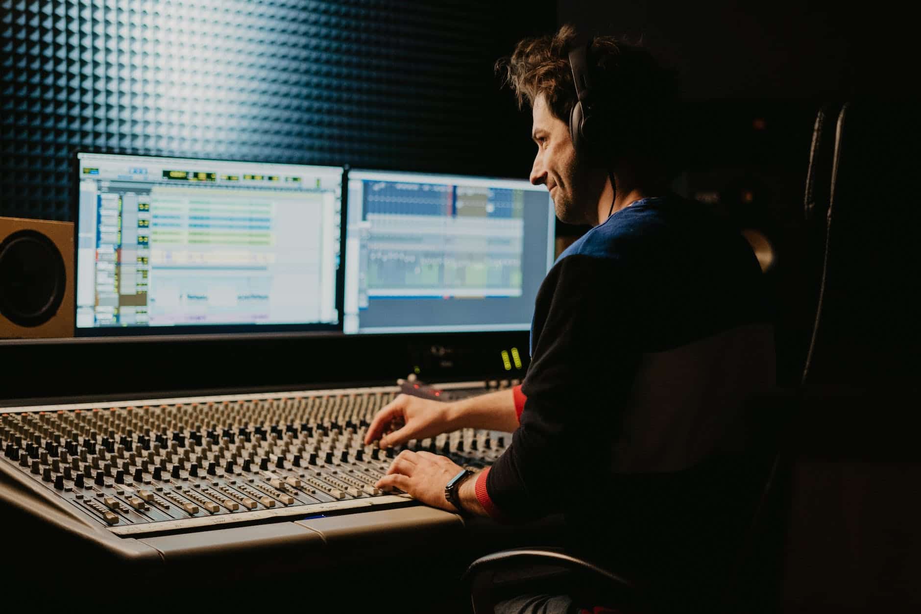 What Is the Difference Between a Sound Engineer and A Sound Designer? 3 a man wearing headphone controlling the audio equipment